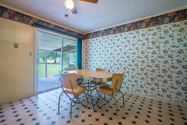 399 Indian Creek Rd, Hohenwald, TN 38462 - dining space featuring tile patterned floors, a textured ceiling, ceiling fan, wallpapered walls, and crown molding