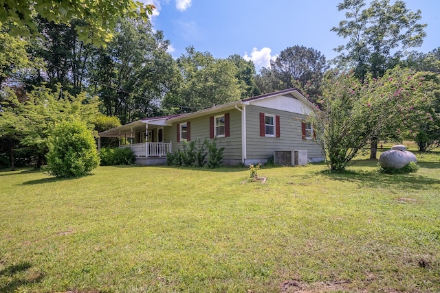 399 Indian Creek Rd, Hohenwald, TN 38462 - view of home's exterior featuring a porch, a lawn, and view of wooded area
