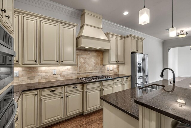1353 Eliot Rd, Franklin, TN 37064 - kitchen featuring cream cabinetry, appliances with stainless steel finishes, custom exhaust hood, pendant lighting, and dark stone countertops