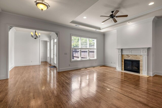 1353 Eliot Rd, Franklin, TN 37064 - unfurnished living room with a chandelier, wood finished floors, a ceiling fan, crown molding, and a fireplace