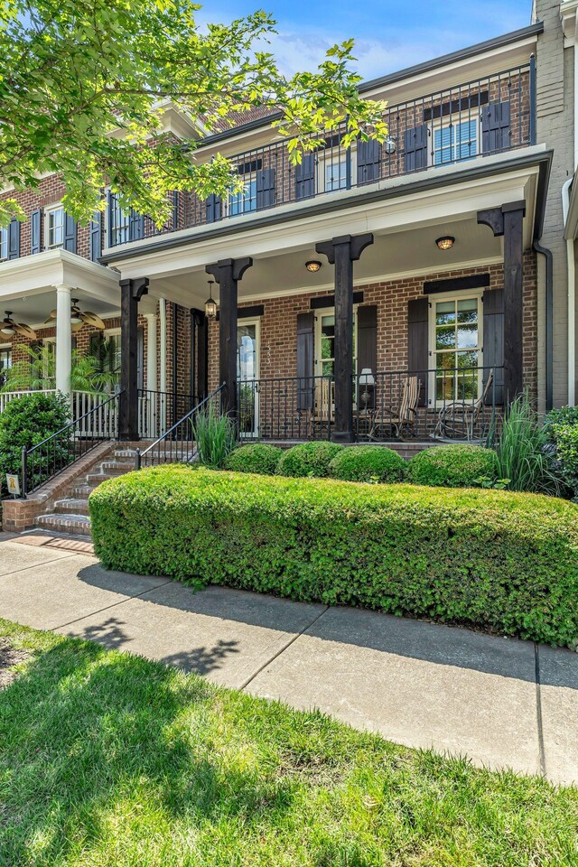 1353 Eliot Rd, Franklin, TN 37064 - view of front of house featuring brick siding, a balcony, and covered porch