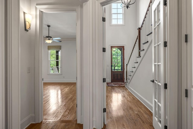 1353 Eliot Rd, Franklin, TN 37064 - foyer with wood finished floors, ceiling fan, ornamental molding, a chandelier, and stairs