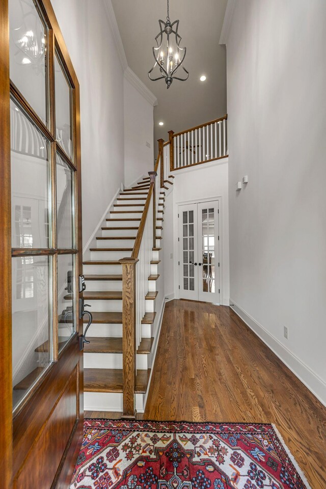 1353 Eliot Rd, Franklin, TN 37064 - stairs featuring french doors, crown molding, a chandelier, wood finished floors, and a high ceiling