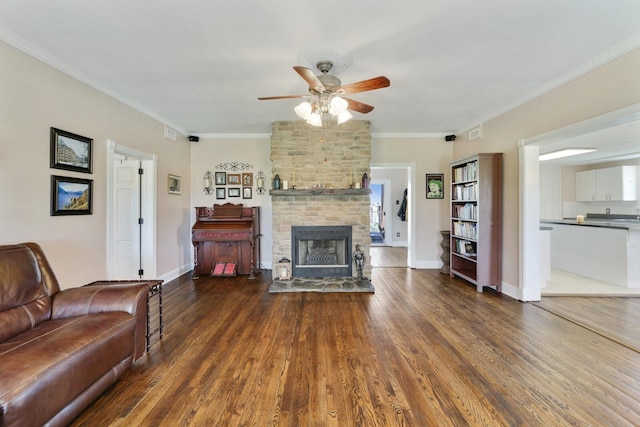 3717 Atkins Rd, Cedar Hill, TN 37032 - living area featuring ceiling fan, wood finished floors, a fireplace, and crown molding