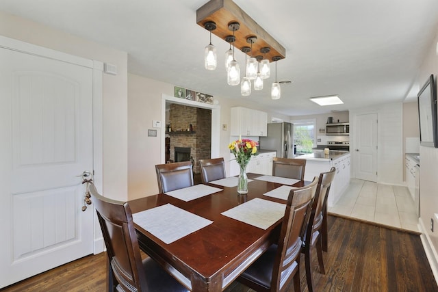 3717 Atkins Rd, Cedar Hill, TN 37032 - dining area with light wood-style flooring and a fireplace