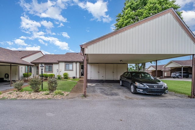 1053 Heritage Dr, Madison, TN 37115 - view of front facade featuring a front yard, a detached carport, asphalt driveway, and a shingled roof