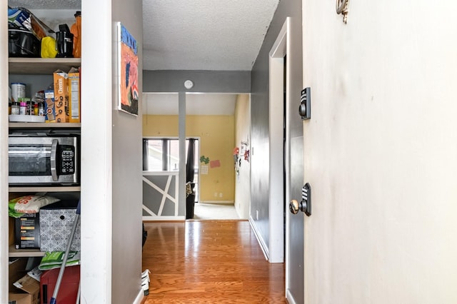 1053 Heritage Dr, Madison, TN 37115 - corridor with wood finished floors and a textured ceiling