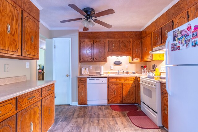 3090 Algee Ln, Milan, TN 38358 - kitchen with white appliances, dark wood-style floors, under cabinet range hood, brown cabinetry, and ceiling fan