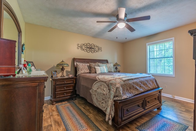 3090 Algee Ln, Milan, TN 38358 - bedroom with wood finished floors, ceiling fan, and a textured ceiling
