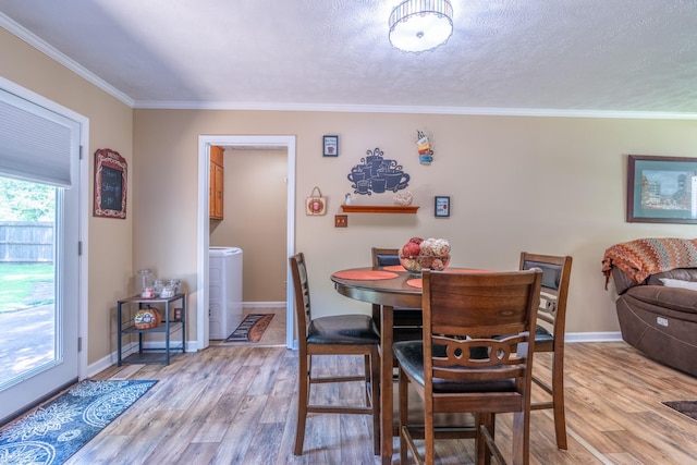 3090 Algee Ln, Milan, TN 38358 - dining room with washer / clothes dryer, light wood finished floors, crown molding, and a textured ceiling