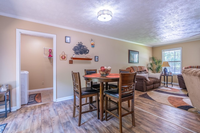 3090 Algee Ln, Milan, TN 38358 - dining room featuring wood finished floors, washer / clothes dryer, a textured ceiling, and crown molding