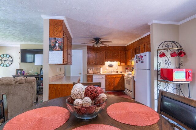 3090 Algee Ln, Milan, TN 38358 - kitchen with white appliances, ceiling fan, brown cabinets, light countertops, and open floor plan