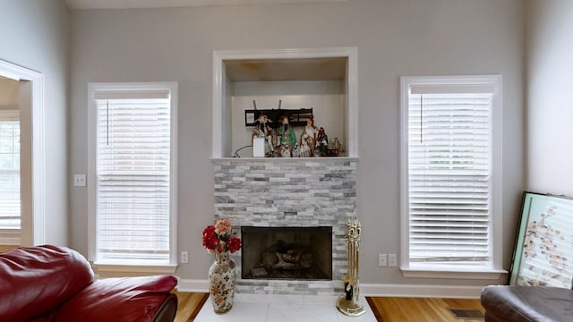 5142 Reagan Dr, Murfreesboro, TN 37129 - living room featuring a stone fireplace, wood finished floors, and plenty of natural light