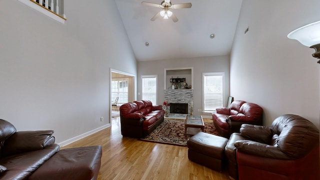 5142 Reagan Dr, Murfreesboro, TN 37129 - living room featuring high vaulted ceiling, ceiling fan, light wood finished floors, and a stone fireplace