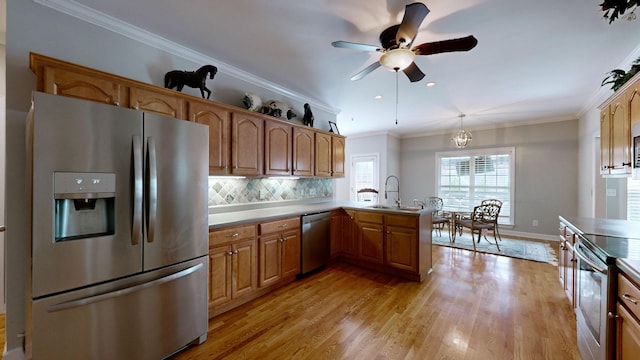 5142 Reagan Dr, Murfreesboro, TN 37129 - kitchen featuring stainless steel appliances, light wood-style floors, ornamental molding, a ceiling fan, and a peninsula