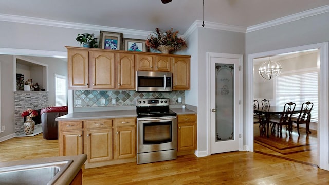 5142 Reagan Dr, Murfreesboro, TN 37129 - kitchen featuring stainless steel appliances, light wood-style floors, crown molding, light countertops, and a chandelier