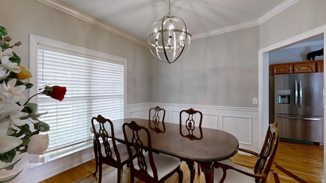 5142 Reagan Dr, Murfreesboro, TN 37129 - dining room featuring a chandelier, crown molding, light wood-style flooring, and wainscoting