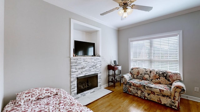 5142 Reagan Dr, Murfreesboro, TN 37129 - living room with crown molding, a fireplace with flush hearth, ceiling fan, and wood finished floors