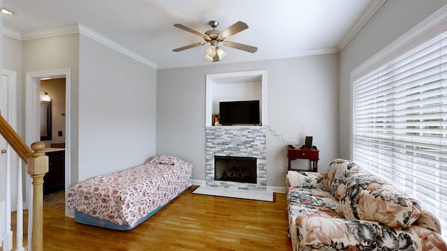 5142 Reagan Dr, Murfreesboro, TN 37129 - living area featuring wood finished floors, ceiling fan, a fireplace, crown molding, and stairs