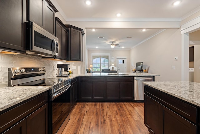 2129 Halfmoon Way, Murfreesboro, TN 37130 - kitchen featuring stainless steel appliances, light wood-style floors, a ceiling fan, crown molding, and light stone counters