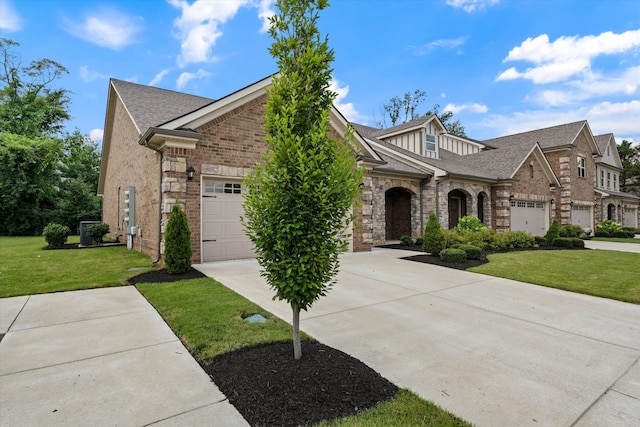 2129 Halfmoon Way, Murfreesboro, TN 37130 - view of front of house featuring a garage, driveway, stone siding, and a front lawn