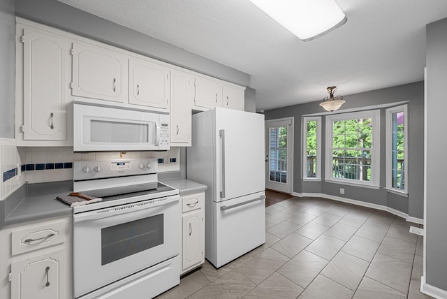 1731 Broadripple Dr, Clarksville, TN 37042 - kitchen featuring white appliances, white cabinets, backsplash, light countertops, and a textured ceiling
