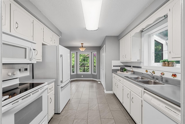 1731 Broadripple Dr, Clarksville, TN 37042 - kitchen featuring white appliances, white cabinetry, light countertops, and a textured ceiling
