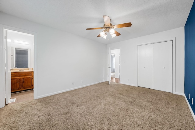 1731 Broadripple Dr, Clarksville, TN 37042 - unfurnished bedroom featuring carpet, a closet, ensuite bathroom, a ceiling fan, and a textured ceiling