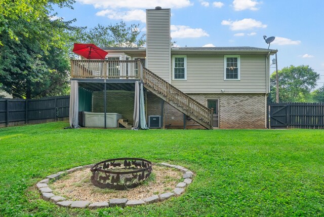 1731 Broadripple Dr, Clarksville, TN 37042 - rear view of house with stairway, an outdoor fire pit, a fenced backyard, and a wooden deck