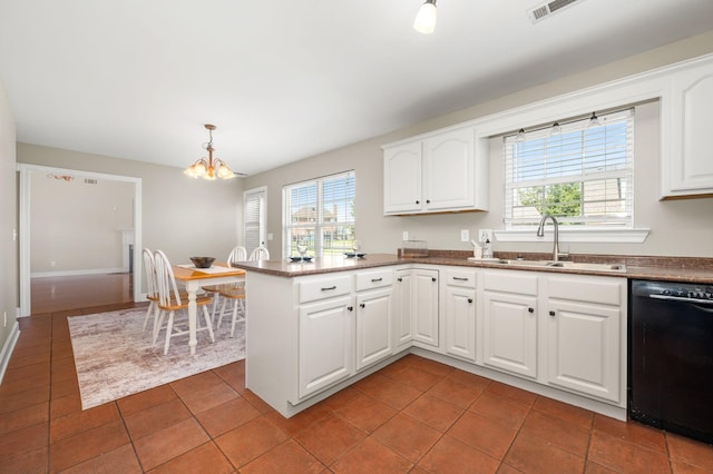 5241 Ticonderoga Ave, Murfreesboro, TN 37129 - kitchen with black dishwasher, a chandelier, a peninsula, tile patterned flooring, and white cabinetry