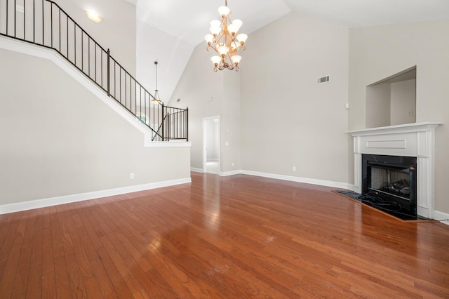 5241 Ticonderoga Ave, Murfreesboro, TN 37129 - unfurnished living room with high vaulted ceiling, stairs, wood finished floors, a chandelier, and a fireplace