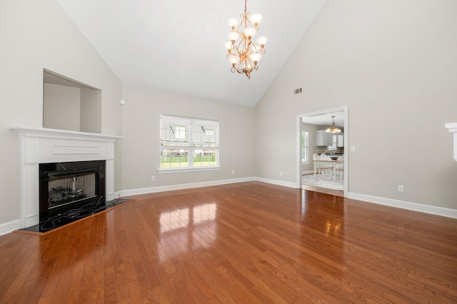 5241 Ticonderoga Ave, Murfreesboro, TN 37129 - unfurnished living room featuring a chandelier, wood finished floors, high vaulted ceiling, and a premium fireplace