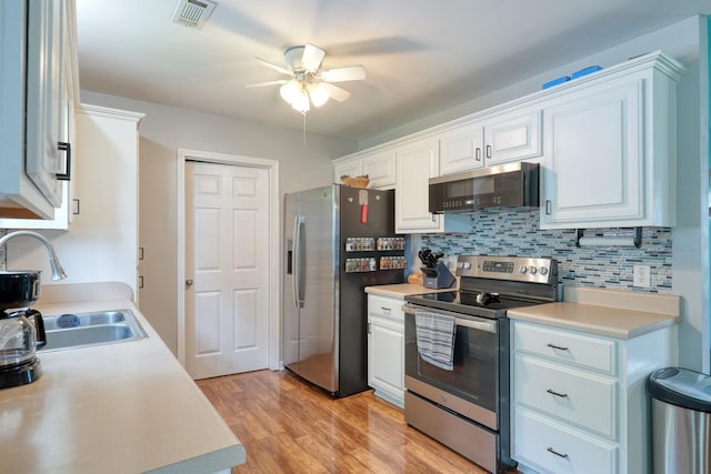 1944 Fieldstone Dr, Columbia, TN 38401 - kitchen with stainless steel appliances, ceiling fan, light countertops, and white cabinets