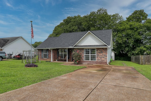 1944 Fieldstone Dr, Columbia, TN 38401 - view of front facade featuring a shingled roof, brick siding, and covered porch