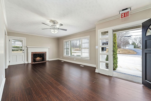 805 N Chancery St, Mcminnville, TN 37110 - unfurnished living room featuring dark wood-style floors, a textured ceiling, a ceiling fan, a brick fireplace, and ornamental molding