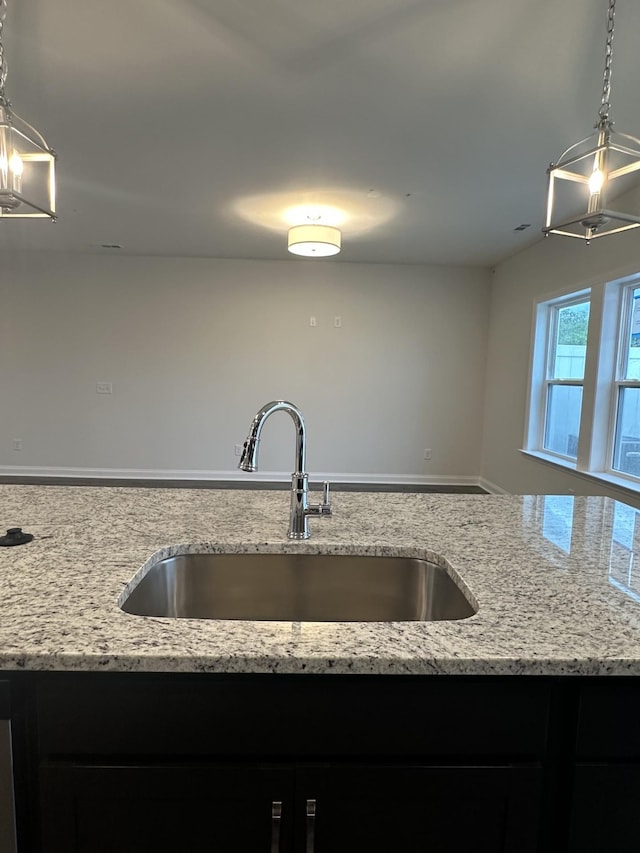 2127 Cheltenham Pl, Columbia, TN 38401 - kitchen featuring light stone counters, a chandelier, open floor plan, and pendant lighting