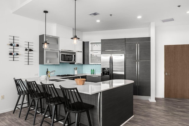 700 12th Ave S Unit 507, Nashville, TN 37203 - kitchen with stainless steel appliances, a peninsula, a breakfast bar, modern cabinets, and recessed lighting