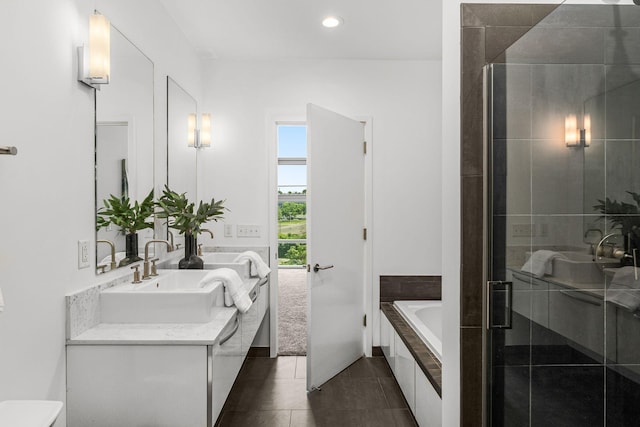700 12th Ave S Unit 507, Nashville, TN 37203 - bathroom featuring a garden tub, double vanity, a stall shower, tile patterned floors, and recessed lighting