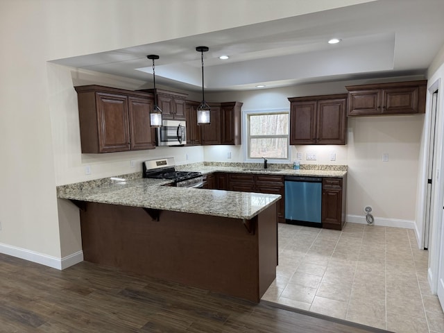 334 Cumberland Cove Rd Unit 5, Monterey, TN 38574 - kitchen featuring appliances with stainless steel finishes, a raised ceiling, a peninsula, light stone countertops, and recessed lighting
