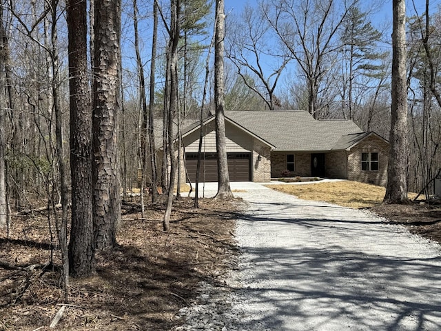 334 Cumberland Cove Rd Unit 5, Monterey, TN 38574 - view of side of property featuring gravel driveway, an attached garage, and roof with shingles