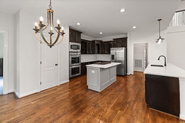630 Black Horse Pkwy, Franklin, TN 37069 - kitchen featuring stainless steel appliances, light countertops, backsplash, dark brown cabinets, and dark wood-style floors