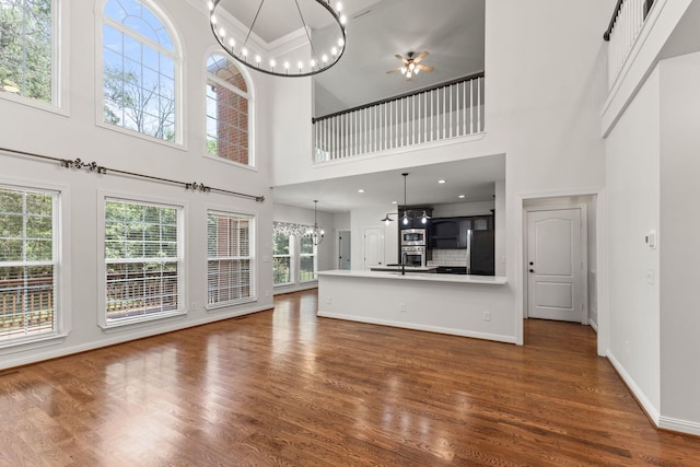 630 Black Horse Pkwy, Franklin, TN 37069 - unfurnished living room featuring a high ceiling, a chandelier, ceiling fan, and wood finished floors