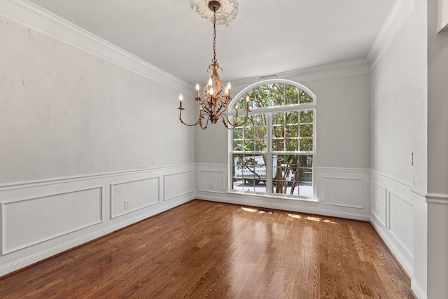 630 Black Horse Pkwy, Franklin, TN 37069 - unfurnished dining area with a chandelier, wainscoting, ornamental molding, wood finished floors, and a decorative wall