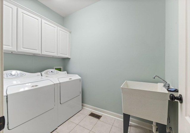630 Black Horse Pkwy, Franklin, TN 37069 - washroom with washer and clothes dryer, cabinet space, and light tile patterned flooring