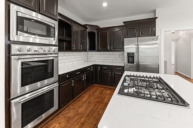 630 Black Horse Pkwy, Franklin, TN 37069 - kitchen with stainless steel appliances, dark wood finished floors, decorative backsplash, dark brown cabinets, and recessed lighting