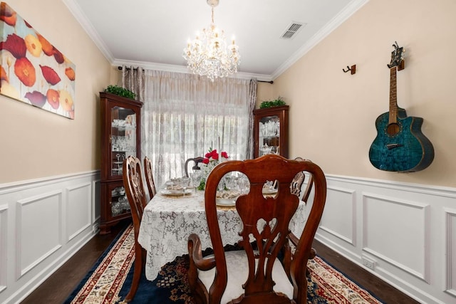 3116 Mapleside Ln, Murfreesboro, TN 37128 - dining room with dark wood-type flooring, a chandelier, crown molding, a decorative wall, and a wainscoted wall