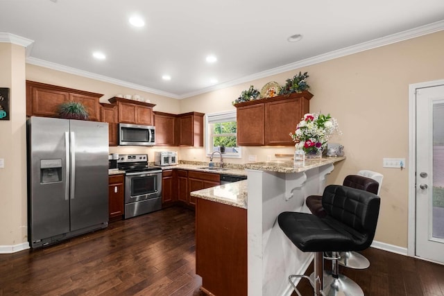 3116 Mapleside Ln, Murfreesboro, TN 37128 - kitchen with stainless steel appliances, a peninsula, a kitchen breakfast bar, light stone counters, and dark wood-style flooring