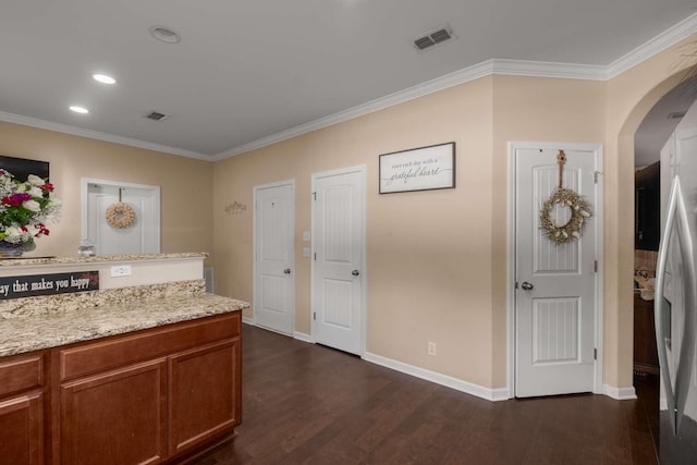 3116 Mapleside Ln, Murfreesboro, TN 37128 - kitchen with dark wood-style flooring, crown molding, arched walkways, brown cabinets, and light stone counters