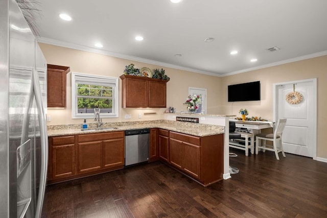 3116 Mapleside Ln, Murfreesboro, TN 37128 - kitchen featuring appliances with stainless steel finishes, a peninsula, ornamental molding, dark wood finished floors, and light stone countertops