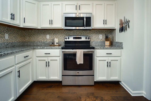 280 Ballygar Ct, Clarksville, TN 37043 - kitchen with appliances with stainless steel finishes, light stone countertops, dark wood-style floors, tasteful backsplash, and white cabinetry